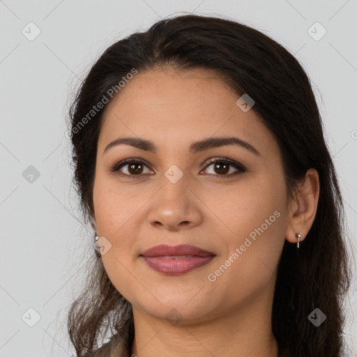 Joyful latino young-adult female with long  brown hair and brown eyes