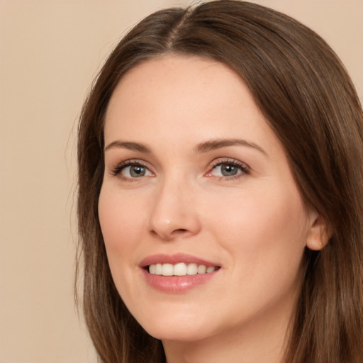 Joyful white young-adult female with long  brown hair and brown eyes