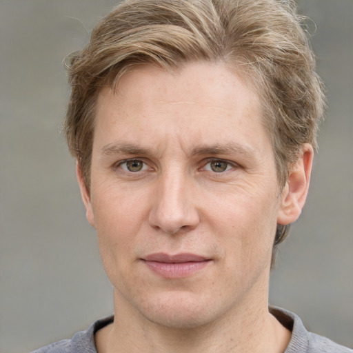 Joyful white adult male with short  brown hair and grey eyes