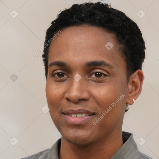 Joyful black young-adult male with short  black hair and brown eyes