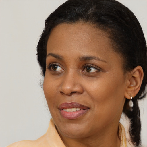Joyful black young-adult female with medium  brown hair and brown eyes
