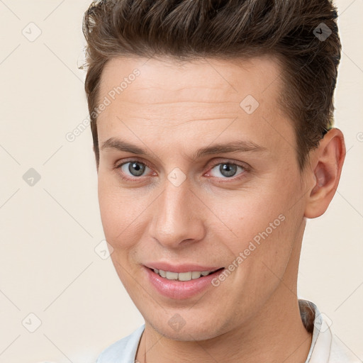 Joyful white young-adult male with short  brown hair and brown eyes