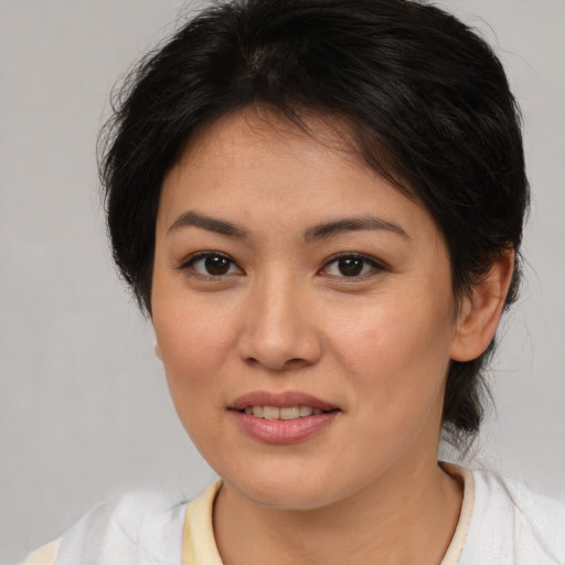 Joyful asian young-adult female with medium  brown hair and brown eyes
