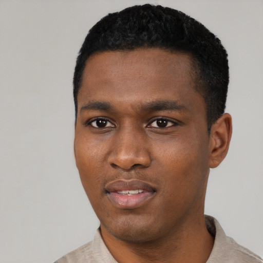 Joyful black young-adult male with short  black hair and brown eyes