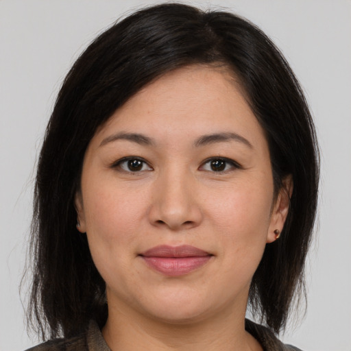 Joyful asian young-adult female with medium  brown hair and brown eyes
