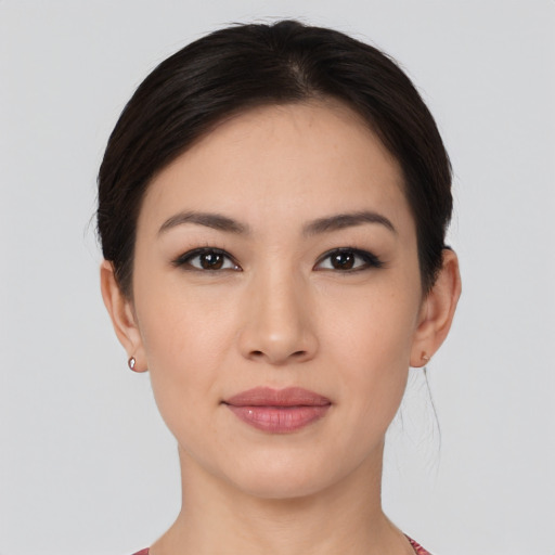 Joyful asian young-adult female with short  brown hair and brown eyes