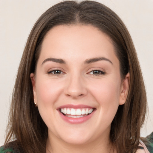 Joyful white young-adult female with medium  brown hair and green eyes