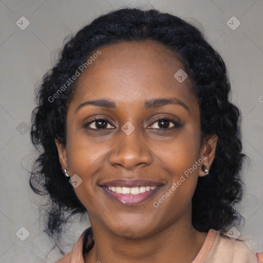 Joyful black young-adult female with long  black hair and brown eyes