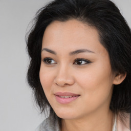 Joyful asian young-adult female with long  brown hair and brown eyes