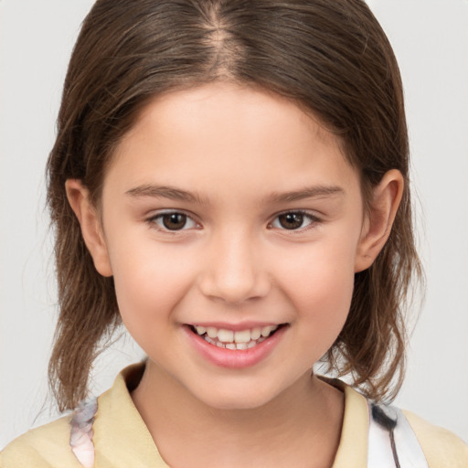 Joyful white child female with medium  brown hair and brown eyes