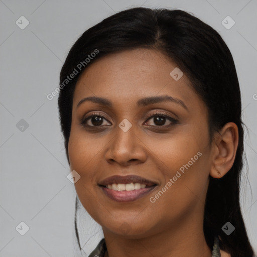 Joyful black young-adult female with long  black hair and brown eyes