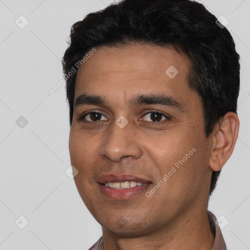 Joyful white young-adult male with short  black hair and brown eyes