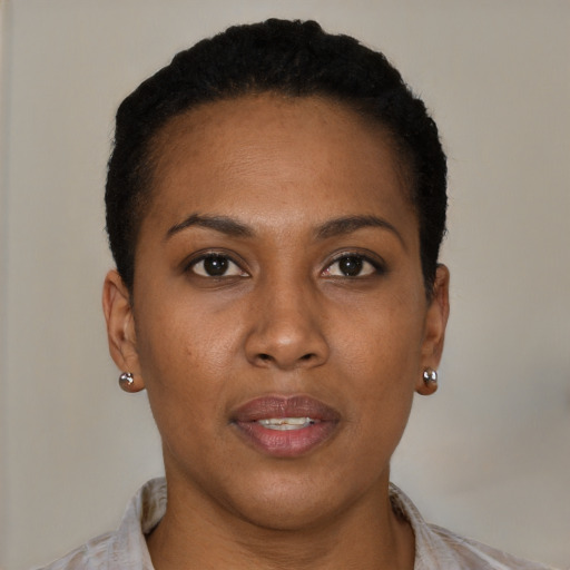 Joyful black young-adult female with short  brown hair and brown eyes