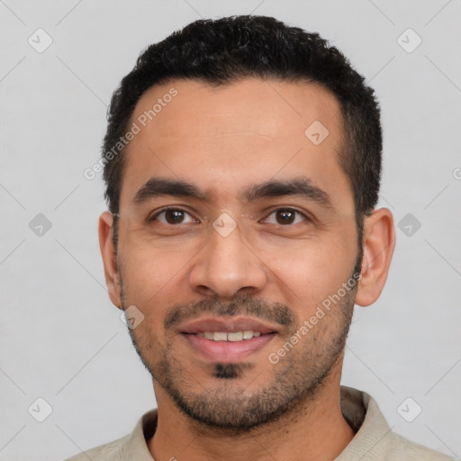 Joyful latino young-adult male with short  black hair and brown eyes