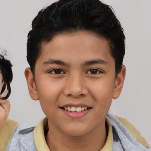 Joyful latino child male with short  brown hair and brown eyes