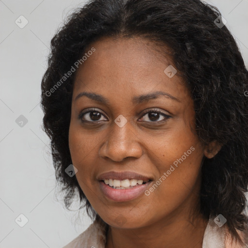 Joyful black young-adult female with long  brown hair and brown eyes