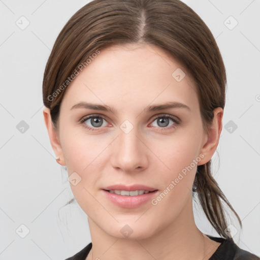 Joyful white young-adult female with medium  brown hair and grey eyes