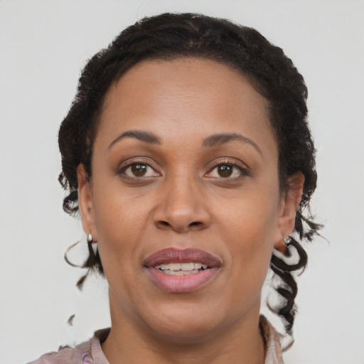 Joyful black young-adult female with medium  brown hair and brown eyes