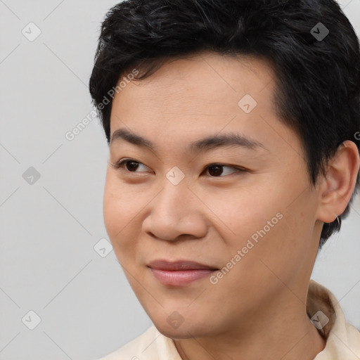 Joyful asian young-adult male with short  black hair and brown eyes