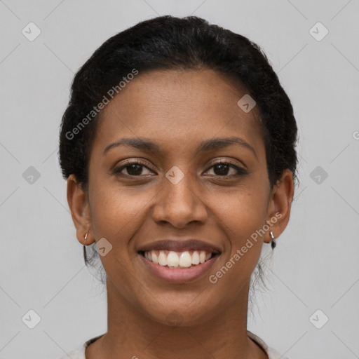 Joyful black young-adult female with short  brown hair and brown eyes