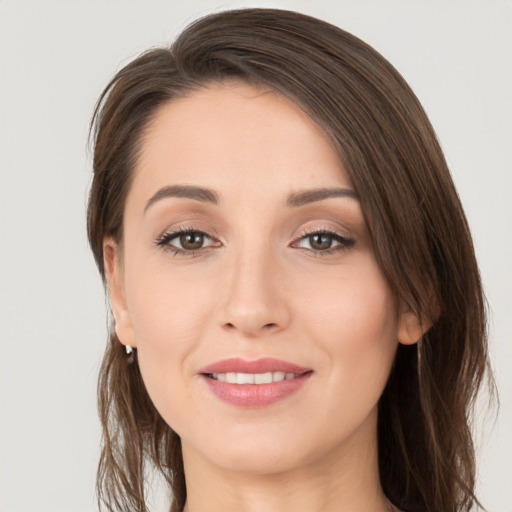 Joyful white young-adult female with long  brown hair and brown eyes