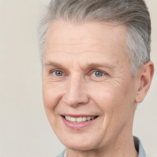 Joyful white middle-aged male with short  brown hair and grey eyes