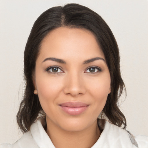 Joyful latino young-adult female with medium  brown hair and brown eyes