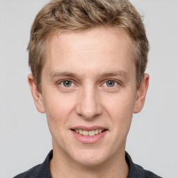 Joyful white adult male with short  brown hair and grey eyes