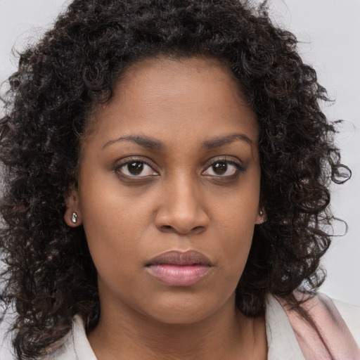Neutral black young-adult female with long  brown hair and brown eyes