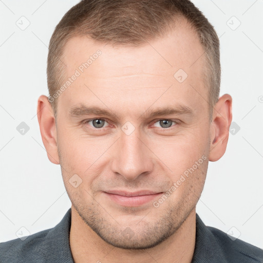 Joyful white young-adult male with short  brown hair and grey eyes