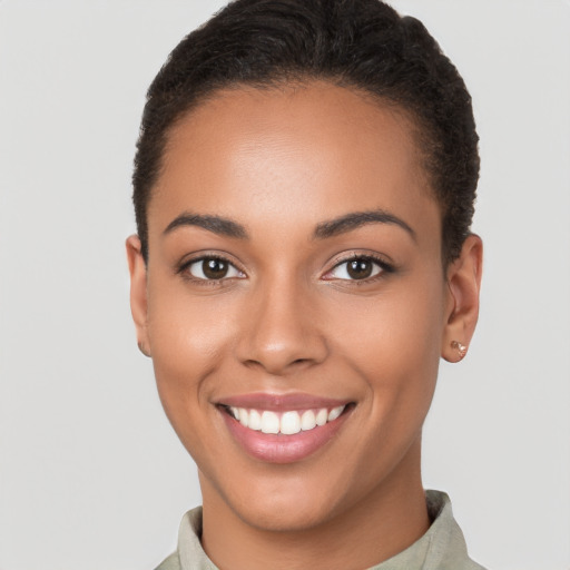 Joyful latino young-adult female with short  brown hair and brown eyes