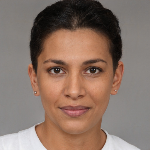 Joyful latino young-adult female with short  brown hair and brown eyes