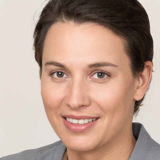 Joyful white adult female with medium  brown hair and brown eyes