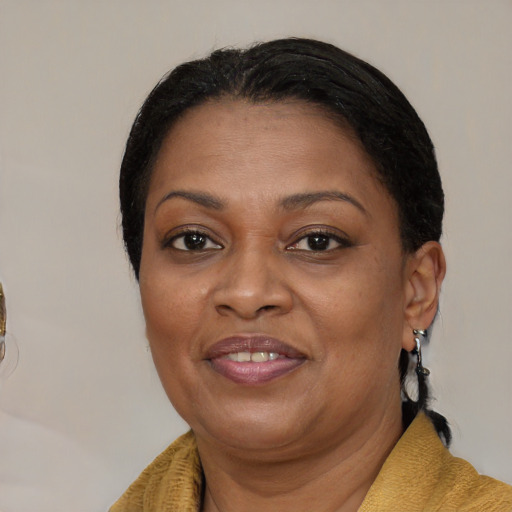 Joyful black adult female with medium  brown hair and brown eyes
