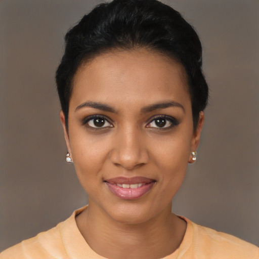 Joyful black young-adult female with short  black hair and brown eyes
