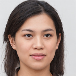 Joyful asian young-adult female with long  brown hair and brown eyes