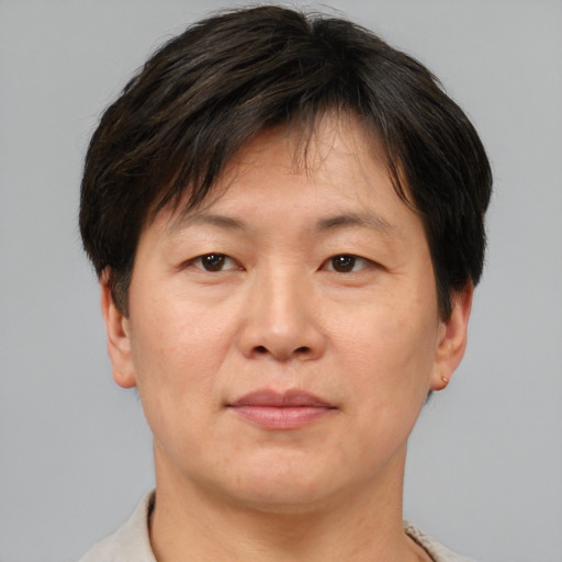 Joyful asian adult male with short  brown hair and brown eyes