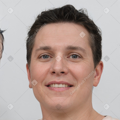 Joyful white young-adult male with short  brown hair and brown eyes