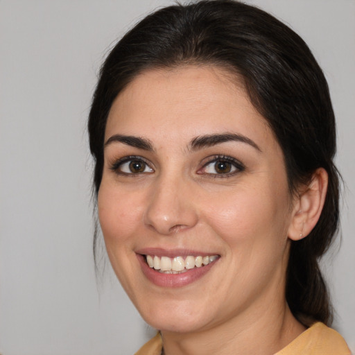 Joyful white young-adult female with medium  brown hair and brown eyes