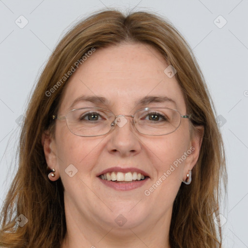 Joyful white adult female with long  brown hair and blue eyes