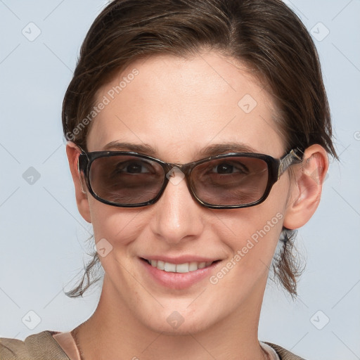 Joyful white young-adult female with medium  brown hair and blue eyes