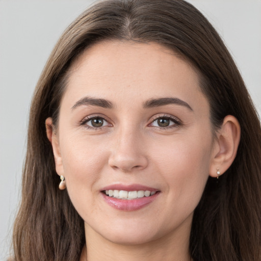 Joyful white young-adult female with long  brown hair and grey eyes