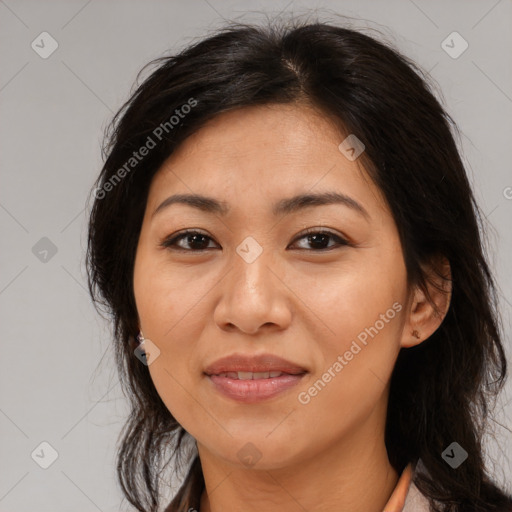 Joyful latino adult female with medium  brown hair and brown eyes