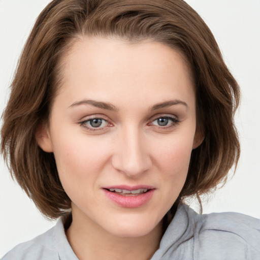 Joyful white young-adult female with medium  brown hair and blue eyes