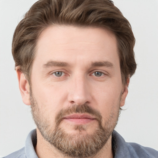 Joyful white adult male with short  brown hair and grey eyes