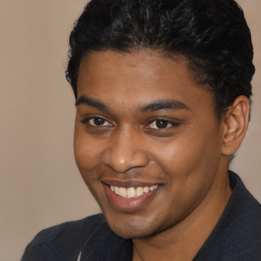 Joyful black young-adult male with short  brown hair and brown eyes