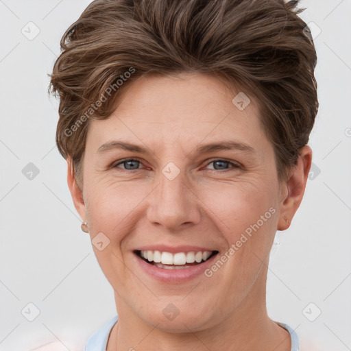 Joyful white young-adult female with short  brown hair and grey eyes