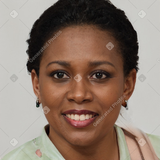 Joyful black young-adult female with short  brown hair and brown eyes