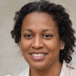 Joyful black adult female with medium  brown hair and brown eyes