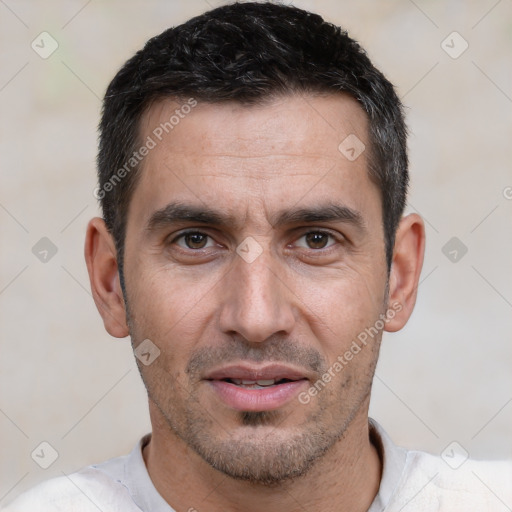 Joyful white adult male with short  black hair and brown eyes